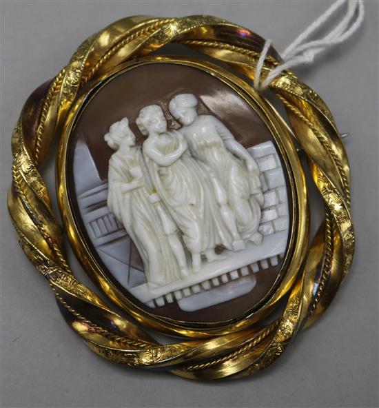 A rolled gold mounted oval shell cameo brooch depicting the Three Graces, 63mm.